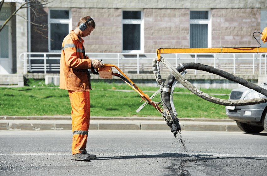 man doing asphalt paving